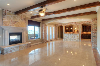 Photo of a large traditional open concept living room in Austin with beige walls, porcelain floors, a two-sided fireplace, a stone fireplace surround and a built-in media wall.