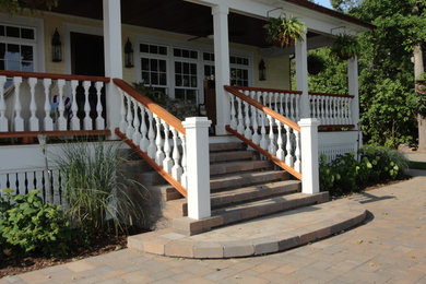This is an example of a large traditional partial sun front yard stone landscaping in New York with a fire pit.