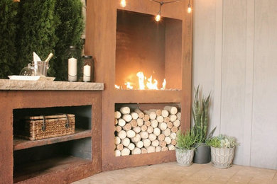 Inspiration for a mid-sized country patio remodel in Other with a fireplace