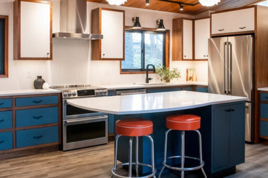 Design ideas for a large midcentury l-shaped eat-in kitchen in Other with an undermount sink, flat-panel cabinets, blue cabinets, quartz benchtops, white splashback, ceramic splashback, stainless steel appliances, laminate floors, with island, grey floor and white benchtop.