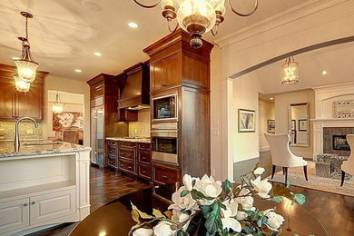 Example of a large classic u-shaped dark wood floor eat-in kitchen design in Calgary with an undermount sink, shaker cabinets, dark wood cabinets, marble countertops, multicolored backsplash, mosaic tile backsplash, stainless steel appliances and an island