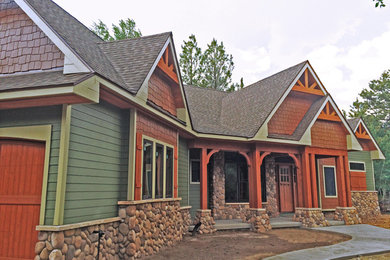 Example of a mid-sized arts and crafts green one-story mixed siding exterior home design in Denver
