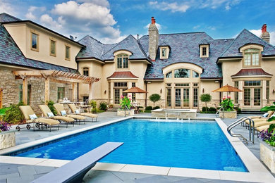Mid-sized elegant courtyard stone and rectangular lap hot tub photo in Chicago