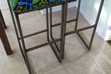 Raw steel stools with upholstered seats