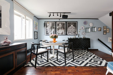 Dining room - eclectic dark wood floor and brown floor dining room idea in London with blue walls and no fireplace