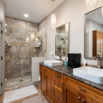 Master Bathroom with Warm Wood Vanity and Travertine Shower