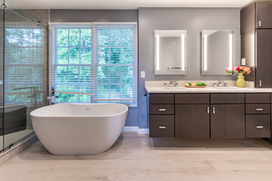 Bathroom - mid-sized contemporary master gray floor and double-sink bathroom idea in DC Metro with flat-panel cabinets, gray cabinets, a one-piece toilet, gray walls, an undermount sink, a hinged shower door, white countertops and a floating vanity