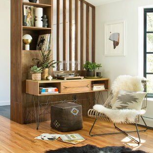 Retro home office and library in Denver with white walls, light hardwood flooring and a freestanding desk.