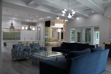 Example of a large transitional open concept porcelain tile, gray floor and coffered ceiling family room design in Miami with gray walls