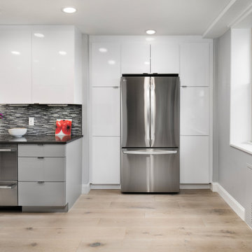 Contemporary High-Gloss Kitchen Remodel | Glass Display Cabinets & Modern Gray B
