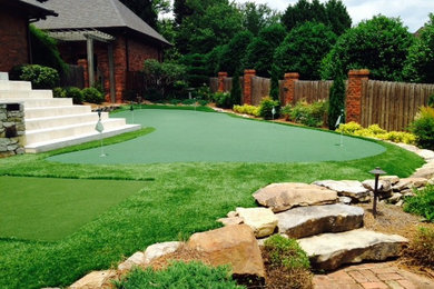 This is an example of a mid-sized traditional partial sun backyard outdoor basketball/tennis/multi-game court in Charlotte.