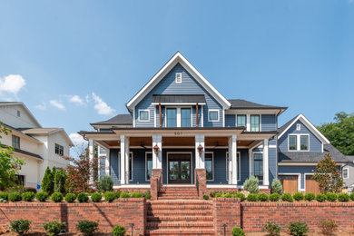 Transitional blue two-story clapboard exterior home photo in Charlotte with a shingle roof and a gray roof