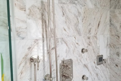 Inspiration for a mid-sized transitional 3/4 beige tile, gray tile, white tile and marble tile multicolored floor corner shower remodel in Toronto with a wall-mount toilet, white walls and a hinged shower door