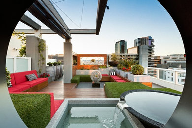 Contemporary patio in Melbourne with a vertical garden, decking and no cover.