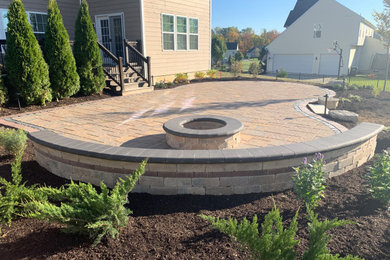 Patio - mid-sized traditional backyard concrete paver patio idea in Other with a fire pit and no cover