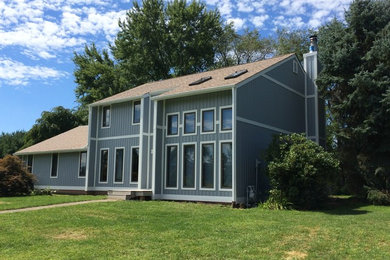 Large elegant blue two-story exterior home photo in Other