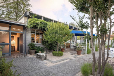 Example of an urban courtyard patio design in San Francisco with an awning