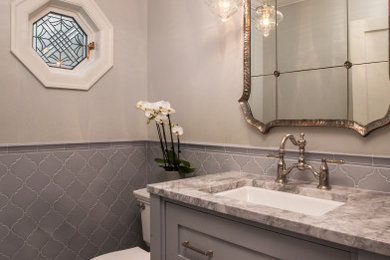 Powder room - small traditional blue tile and porcelain tile porcelain tile, white floor and wainscoting powder room idea in Seattle with shaker cabinets, blue cabinets, a two-piece toilet, blue walls, an undermount sink, quartzite countertops, white countertops and a freestanding vanity