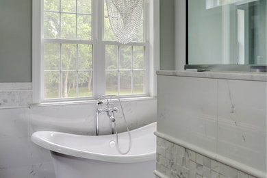 Example of a large transitional master white tile and porcelain tile porcelain tile and gray floor bathroom design in Philadelphia with raised-panel cabinets, brown cabinets, a two-piece toilet, gray walls, an undermount sink, quartz countertops and a hinged shower door