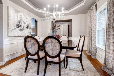 Mid-sized transitional light wood floor enclosed dining room photo in Denver with gray walls and no fireplace