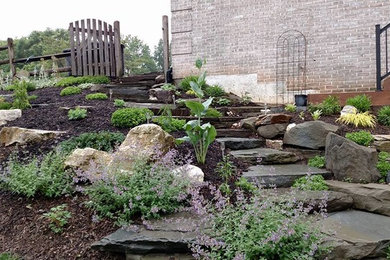 Photo of a mid-sized rustic full sun backyard stone formal garden in Baltimore.