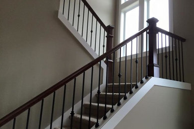 Example of a large classic carpeted u-shaped wood railing staircase design in Portland with carpeted risers