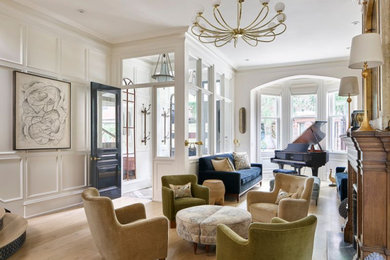 Living room - modern light wood floor, brown floor and wall paneling living room idea in Philadelphia with white walls, a standard fireplace and a wood fireplace surround