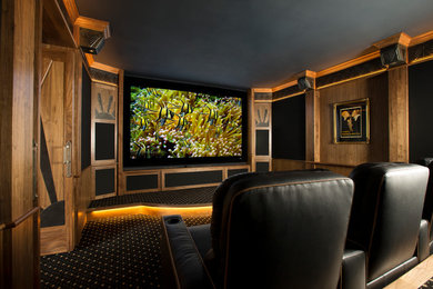 Mid-sized elegant enclosed carpeted home theater photo in Albuquerque with brown walls and a projector screen