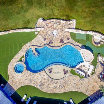 Overhead view of resort style pool, flagstone decking and artificial turf