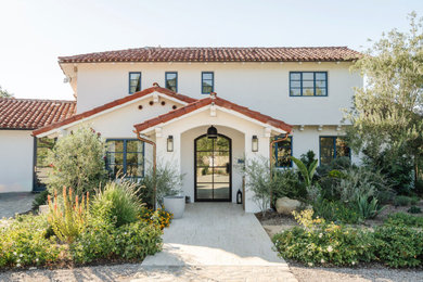 Huge tuscan white two-story stucco house exterior photo in Los Angeles with a hip roof, a tile roof and a red roof
