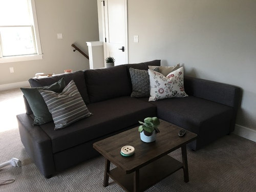 dark grey couch with pillows