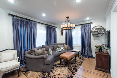 Family room - mid-sized transitional open concept light wood floor family room idea in Atlanta with white walls, no fireplace and a wall-mounted tv