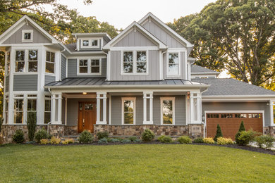 Large transitional gray two-story concrete fiberboard house exterior idea in DC Metro with a shingle roof