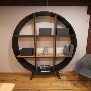 Photo of a large modern home office and library in Manchester with a wooden fireplace surround.