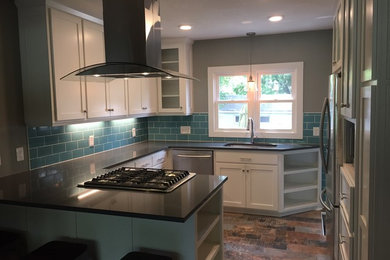 Inspiration for a small timeless u-shaped ceramic tile and multicolored floor eat-in kitchen remodel in Minneapolis with a single-bowl sink, shaker cabinets, white cabinets, quartz countertops, green backsplash, subway tile backsplash, stainless steel appliances and a peninsula