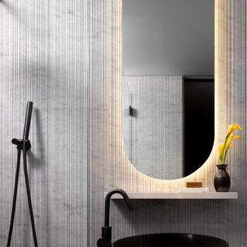 Powder Room with Textured Tile and Backlit Mirror