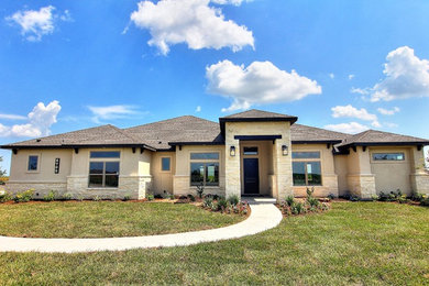 Example of a transitional beige one-story mixed siding house exterior design in Other with a hip roof and a shingle roof