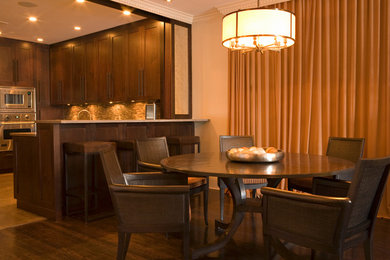 Example of a large trendy dark wood floor kitchen/dining room combo design in New York with beige walls and no fireplace