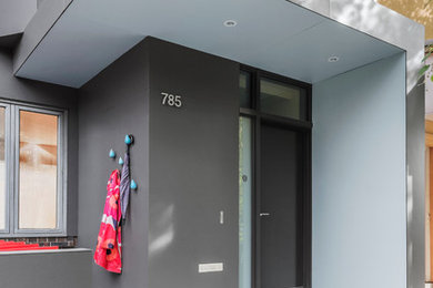 Small trendy concrete front porch photo in Toronto with an awning