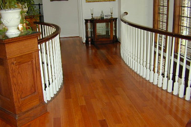 Example of a medium tone wood floor hallway design in DC Metro with white walls