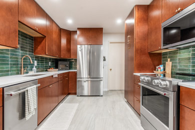Example of a mid-sized transitional galley eat-in kitchen design in Columbus with flat-panel cabinets, light wood cabinets, quartz countertops, green backsplash and porcelain backsplash
