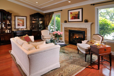 Living room - traditional medium tone wood floor living room idea in San Francisco with a standard fireplace and a stone fireplace