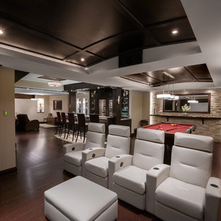 Example of a large trendy open concept dark wood floor home theater design in Ottawa with beige walls and a projector screen