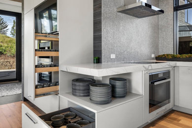 Example of a trendy bamboo floor, brown floor and exposed beam kitchen design in Denver with a farmhouse sink, quartz countertops, gray backsplash, ceramic backsplash, stainless steel appliances and white countertops