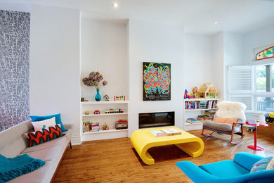 This is an example of a mid-sized contemporary open concept living room in Toronto with white walls, medium hardwood floors, a ribbon fireplace, a plaster fireplace surround and no tv.