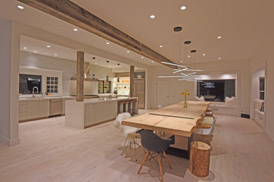 This is an example of a country kitchen/dining combo in Other with light hardwood floors.