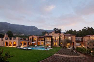 Example of a tuscan beige split-level exterior home design in Los Angeles