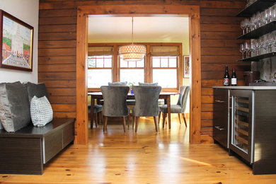 Wet bar - mid-sized transitional single-wall medium tone wood floor and brown floor wet bar idea in Denver with flat-panel cabinets, brown cabinets, gray backsplash and wood backsplash