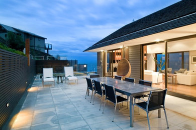 This is an example of a mid-sized contemporary side yard patio in Melbourne with no cover and concrete pavers.