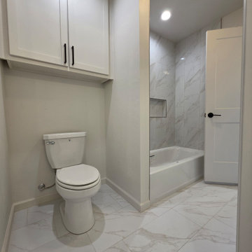Shared bathroom space surrounded in porcelain tile